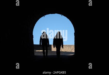 23 January 2020, Baden-Wuerttemberg, Neuffen: Two women are walking through a passageway of the castle ruin Hohenneuffen. Photo: Marijan Murat/dpa Stock Photo