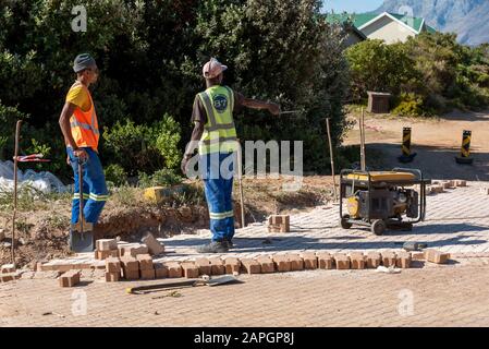Rooiels, Western Cape, South Africa. December 2019. Workers laying a brick road in the small hamlet of Rooiels. Stock Photo
