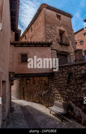 Narrow medieval alley way with passage made of terracotta red stone in Albarracin Spain Stock Photo