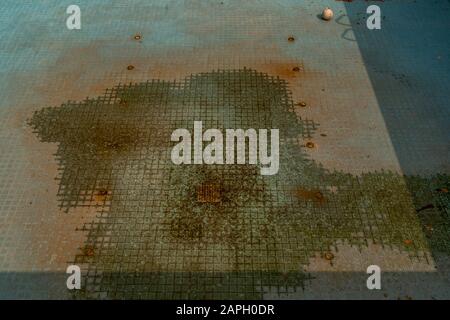 A dirty, abandoned swimming pool without water, Old Swimming Pool. Stock Photo