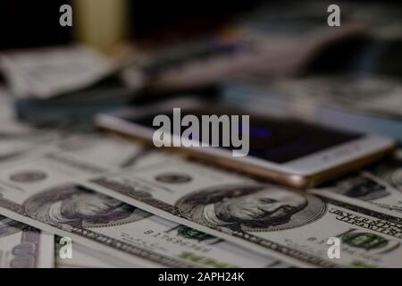 Stack of 100 US dollars banknotes a lot of, money on blurred background Stock Photo