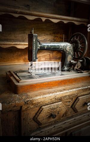 Vintage Singer sewing machine threaded with spool of white thread on white  Stock Photo - Alamy