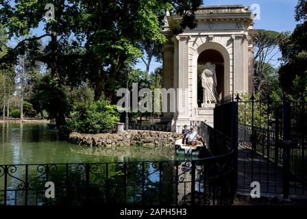 boaters on a lake in Villa Borghese park in Rome on a summer day Stock Photo