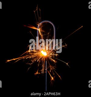 Burning sparkler in shape of number zero, digit 0, isolated on black background. Stock Photo