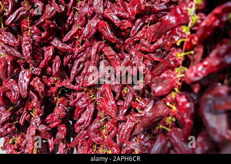 String of dried red peppers, sellers sell it like this in the streets of Granada. Stock Photo