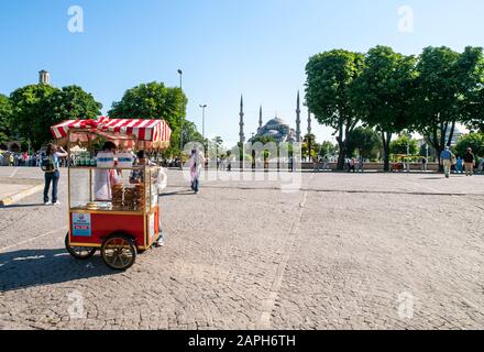 Istanbul / Turkey  Bagel seller stall and Blue mosque in the background, clear blue sky summer day. Stock Photo