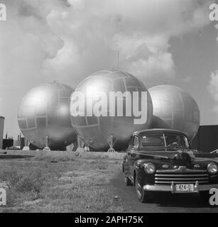 Travel to Suriname and the Netherlands Antilles Description: The car of photographer Van de Poll at the Lago oil refinery in San Nicolas on Aruba Date: 1947 Location: Aruba, San Nicolas Keywords: cars, refineries Institution name: Lago Stock Photo