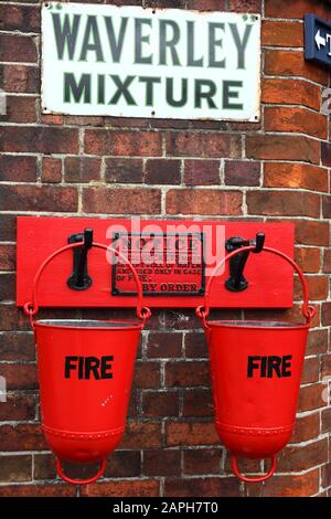 Fire buckets and old fashioned Waverley Mixture tobacco advert on station building wall, Tenterden Town station, Kent & East Sussex Railway, Kent, Eng
