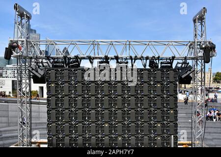 Rear of modular electronic TV panels & cable connections at back of big outdoor television screen public entertainment The Scoop Southwark London UK Stock Photo