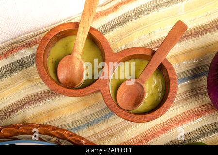 Green sauce with ingredients: green tomato, avocato, coriander, parsley and garlic Stock Photo