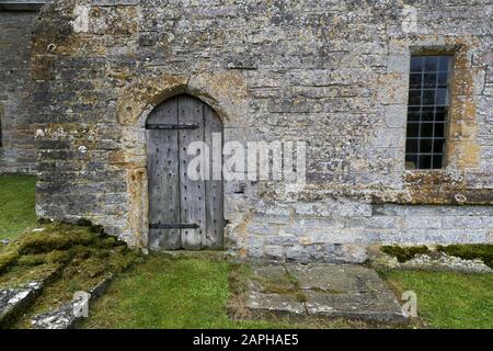 detail of ancient wooden door in a medieval old stone building in Devon, England, UK Stock Photo