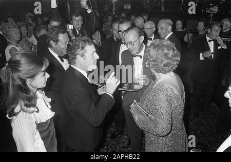 Queen Juliana and Prince Bernhard attend the Dutch gala premiere of film Battle of Britain at the Tuschinski Theater in Amsterdam Description: The English actor Kenneth More offers Prince Bernhard and Queen Juliana a model of a Spitfire to Date: 25 September 1969 Location: Amsterdam, Noord-Holland Keywords: actors, flowers, films, queens, premieres, theaters Personal name: Bernhard (prince Netherlands), Juliana (queen Netherlands), More, Kenneth Institution name: Spitfire Stock Photo
