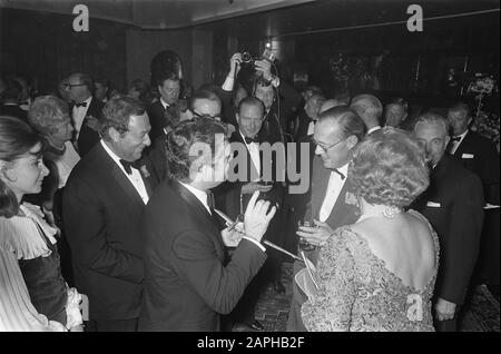 Queen Juliana and Prince Bernhard attend the Dutch gala premiere of film Battle of Britain at the Tuschinski Theater in Amsterdam Description: The English actor Kenneth More in conversation with Prince Bernhard and Queen - Juliana. - Yeah. In his hand a model of a Spitfire Date: 25 September 1969 Location: Amsterdam, Noord-Holland Keywords: actors, flowers, films, queens, premieres, theaters Personal name: Bernhard (prince Netherlands), Juliana (queen Netherlands), More, Kenneth Stock Photo