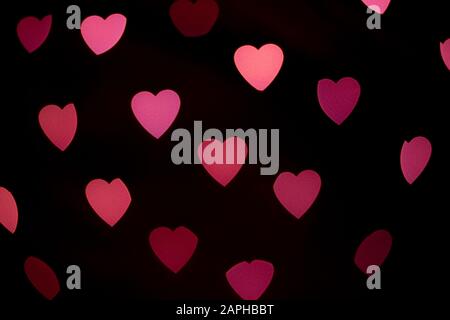 Valentines background. Abstract heart bokeh background. Defocused blurred heart shaped lights. Valentines Day background Stock Photo