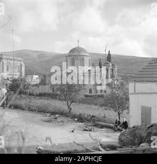 Israel 1948-1949: Kana Description: The Greek Orthodox Wedding Church, with in the foreground two villagers surrounded by scurrying chickens Date: 1948 Location: Israel, Cana Keywords: village statues, church buildings, chickens, towers Stock Photo