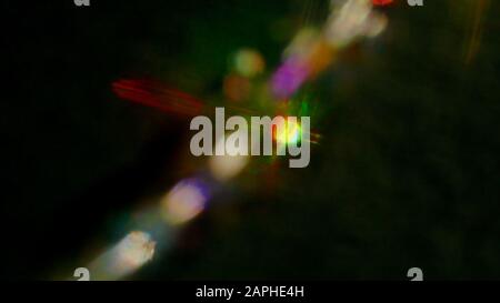 Multicolored light reflections on a black background. Surrealistic image. Abstract image. Stock Photo