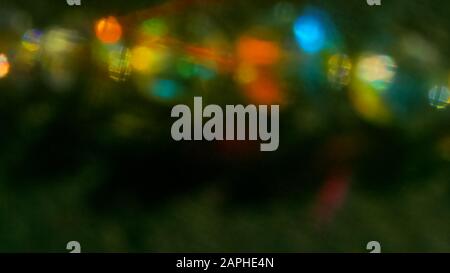 Multicolored light reflections on a black background. Surrealistic image. Abstract image. Stock Photo