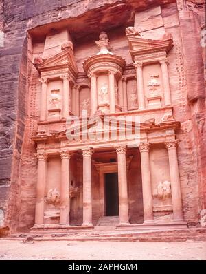 Jordan. The Treasury Building, the Khazaneh at the entrance to the World famous UNESCO World Heritage Site of the Nabatean and Roman  ruins and relics at the desert town of Petra much used as a motion picture film set such as Indiana Jones Temple of Doom, now a very popular tourist attraction. Of interest is that the carvings of of people perhaps Gods have no faces or legs. These were hacked or shot off during early Islamic times as images of Infidels Stock Photo