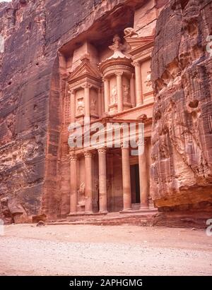 Jordan. The Treasury Building, the Khazaneh at the entrance to the World famous UNESCO World Heritage Site of the Nabatean and Roman  ruins and relics at the desert town of Petra much used as a motion picture film set such as Indiana Jones Temple of Doom, now a very popular tourist attraction. Of interest is that the carvings of of people perhaps Gods have no faces or legs. These were hacked or shot off during early Islamic times as images of Infidels Stock Photo