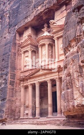 Jordan. The Treasury Building, the Khazaneh at the entrance to the World famous UNESCO World Heritage Site of the Nabatean and Roman  ruins and relics at the desert town of Petra much used as a motion picture film set such as Indiana Jones Temple of Doom, now a very popular tourist attraction. Of interest is that the carvings of of people perhaps Gods have no faces or legs. These were hacked or shot off during early Islamic times as images of Infidels Stock Photo