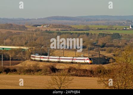 A Class 800 Azuma bi-mode multiple unit number 800103 working a diverted LNER service approaches Letchworth after crossing the Hitchin Flyover. Stock Photo