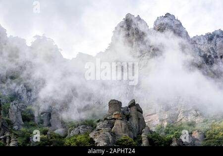 The Demerdji mountain with low lying clouds. Valley of ghosts. Landscape of Crimea, Russia. Stock Photo