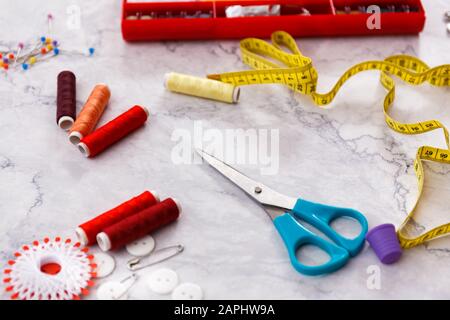 colorful sewing and tailoring tools and items on light background Stock Photo