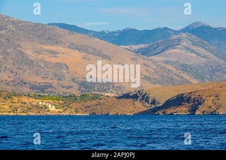 Greece. The hilly coast of the Gulf of Corinth. Summer day. Several cottages on the slope of a hilly coast Stock Photo