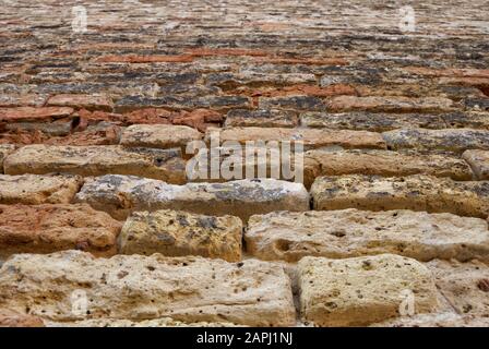 Ancient stone wall texture with orange-brown cast. Stock Photo