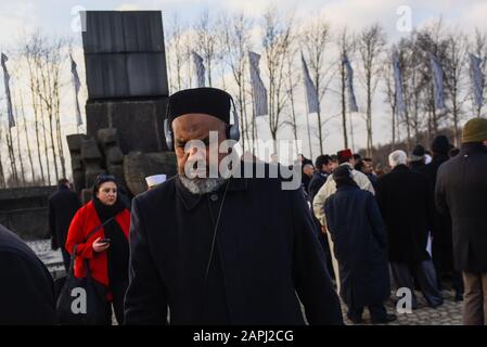 A member of the delegation of the Muslim World League attends a ceremony in front of the International Monument to the Victims of Fascism at the former Nazi-German concentration and extermination camp KL Auschwitz II-Birkenau ahead of the 75th Anniversary of Auschwitz Liberation. Stock Photo