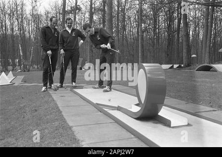 the team of Feijenoord trains in sports centre Zeist for the match against Legia (Warsaw) Description: The footballers Pieters Graafland, Treytel and Hook on the miniature golf course Date: 14 April 1970 Location: Utrecht, Zeist Keywords: minigolf, sports centers, football Person name: Hook, Guus, Pieters Graafland, Eddy, Treytel, Eddie Stock Photo