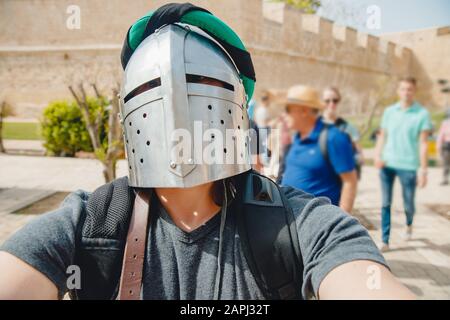 Selfie photo of man wearing knight helmet with armor Viking festival, Malta. Stock Photo