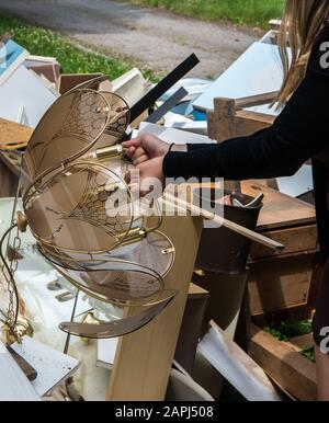 Woman takes lamp from bulky waste Stock Photo
