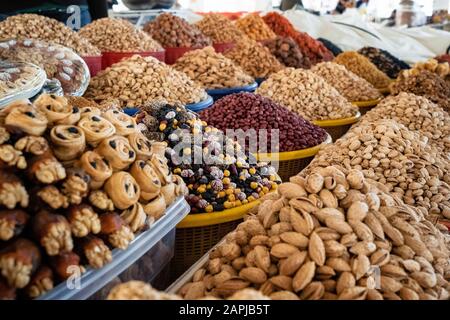 View of colorful sweets and nuts on showcase of local food market, Uzbekistan Stock Photo