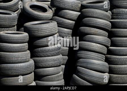 stack of worn tires of different types Stock Photo