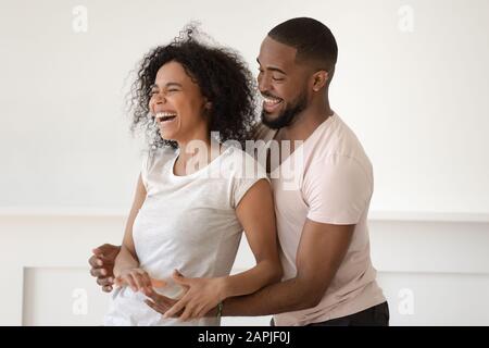African couple spending weekend fooling around having fun at home Stock Photo