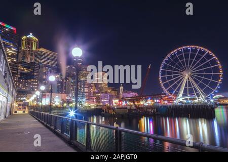 Seattle Great Wheel at Pier 57 and view of downtown at night time, Seattle, Washington, United States. Stock Photo