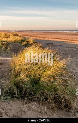 Late afternoon sunlight on Brancaster beach on the North Norfolk coast. Stock Photo