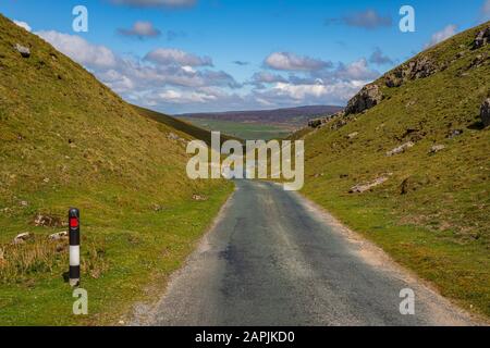 Rural road in the Yorkshire Dales near Askrigg, North Yorkshire, England, UK