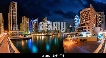 Dubai Marina at night, with the skyline and colorful reflections on the water Stock Photo