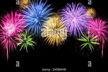 Colorful fireworks shaped like an arch with black copy space underneath Stock Photo