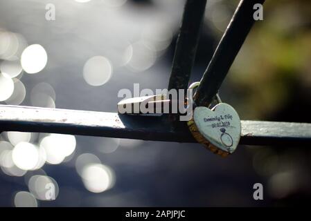 Heart shaped love padlock - beautiful wedding day custom. Shallow depth of field Stock Photo