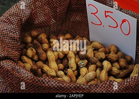 Peanuts in husks in bag with price in euro Stock Photo