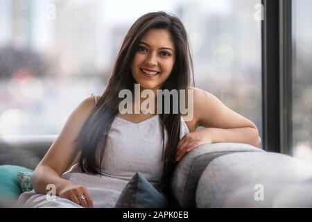 Beautiful headshot portrait of an indian, latina, hispanic woman, natural, friendly and charming bright smile with perfect teeth Stock Photo