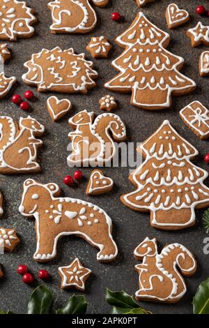 Animal and tree shaped Christmas gingerbread cookies on a dark background Stock Photo
