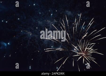 Flashes of white fireworks, with smoke and tracers. Stock Photo