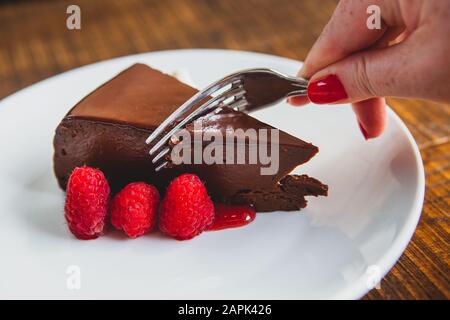 Delicious slice of chocolate mouse cake with raspberries and whipped cream Stock Photo