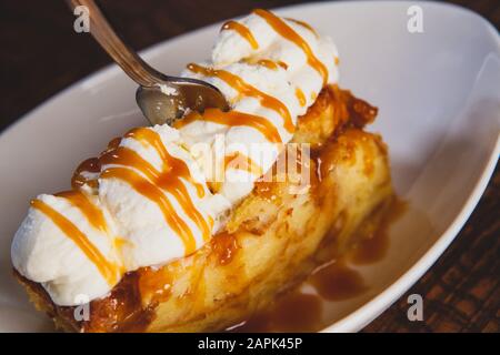 Bread pudding dessert sitting on a wooden table. Stock Photo