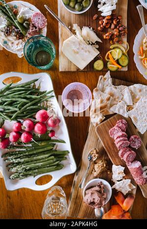 Spread of appetizers on wooden cutting boards and table. Stock Photo