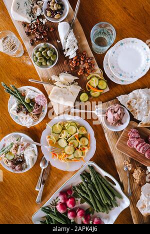 Spread of appetizers on wooden cutting boards and table. Stock Photo